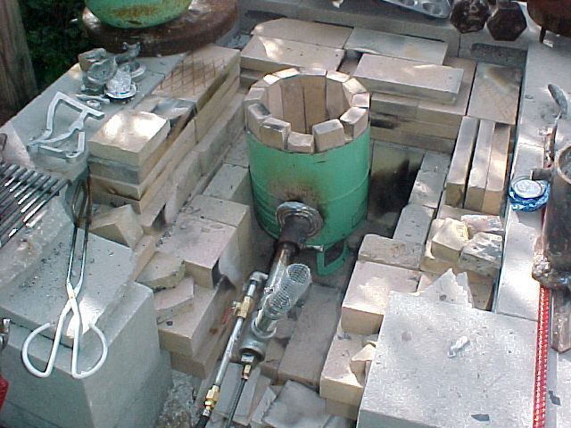 freon tank furnace with firebrick and burner in place in the gigantor fireplace.jpg